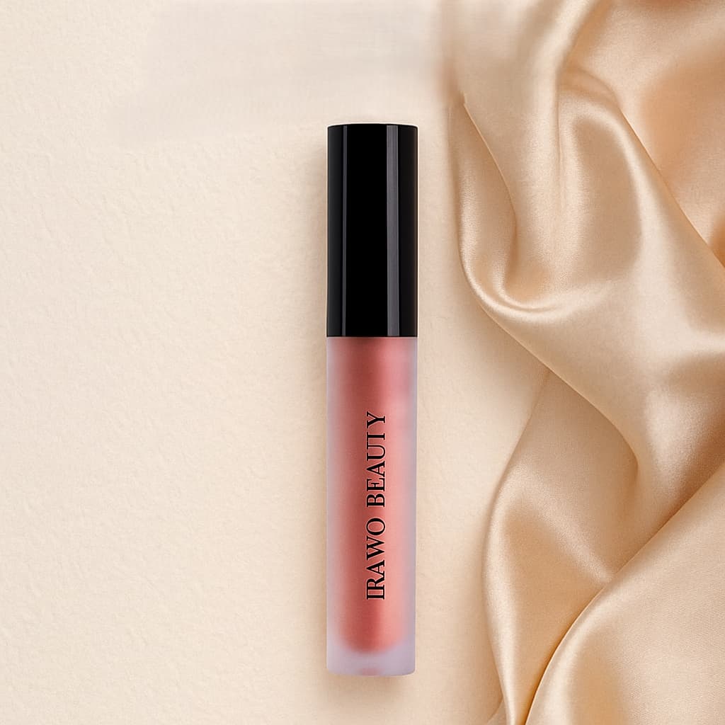 Lip gloss with black cap on a beige satin background