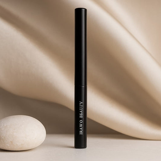 Black cosmetic tube with 'IRAWO BEAUTY' branding on a beige background