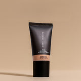 Tube of Irawo Beauty foundation on a beige background
