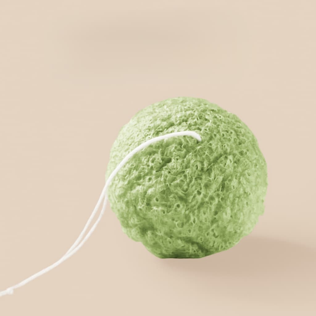 Green sponge on a beige background
