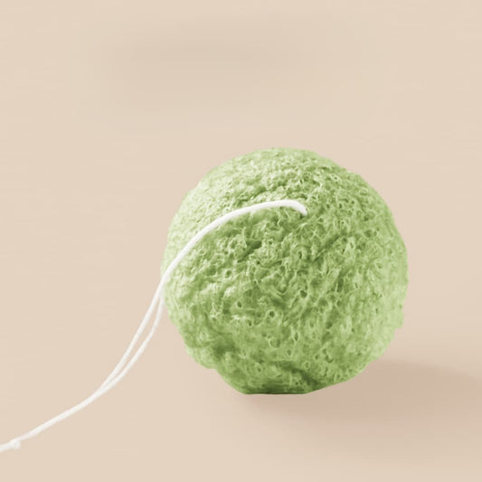 Green sponge on a beige background
