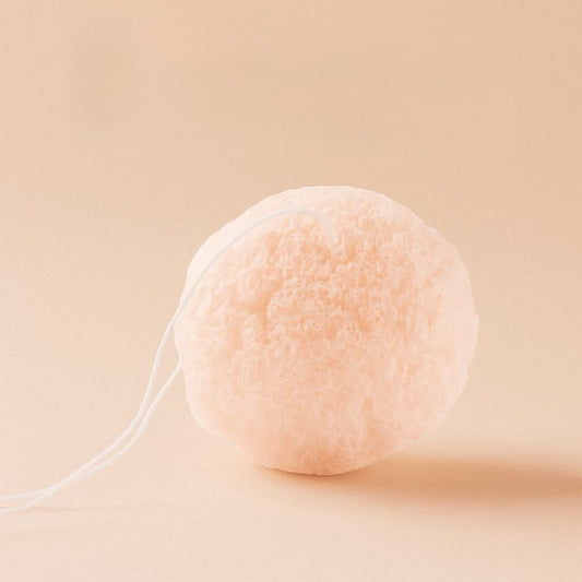 Cherry Blossom Konjac sponge with a string on a beige background