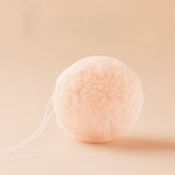 Cherry Blossom Konjac sponge with a string on a beige background