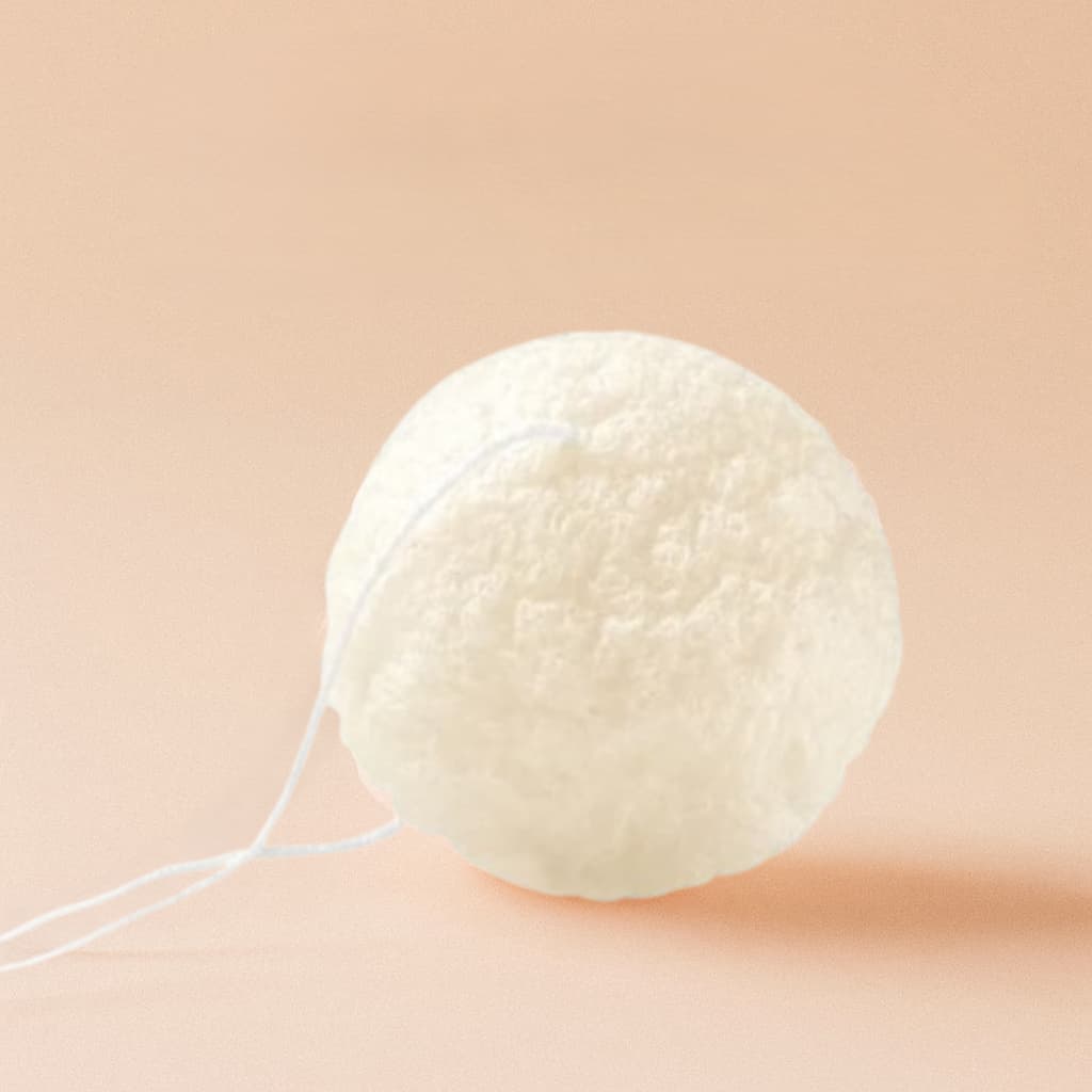 White Konjac sponge on a beige background
