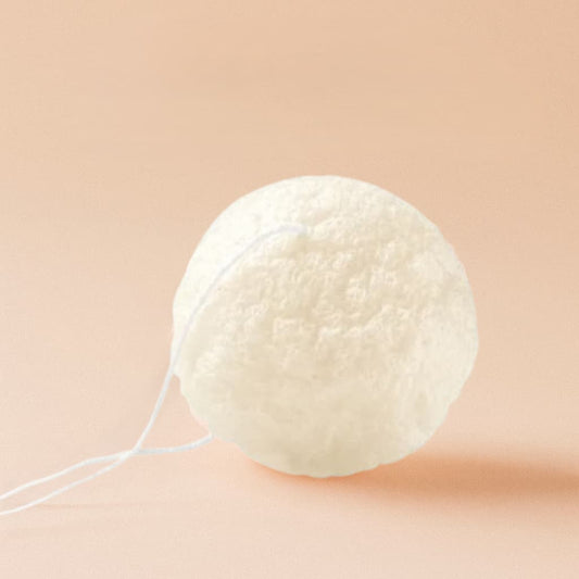 White Konjac sponge on a beige background