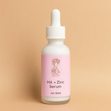 HA + Zinc Serum bottle with pink label on a beige background