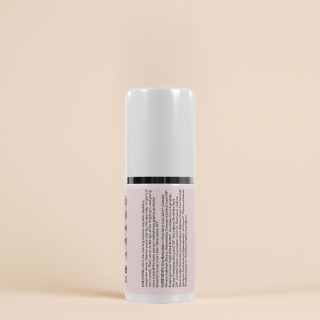 Skincare serum bottle with text label on a beige background