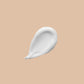 White cream smear on a beige background