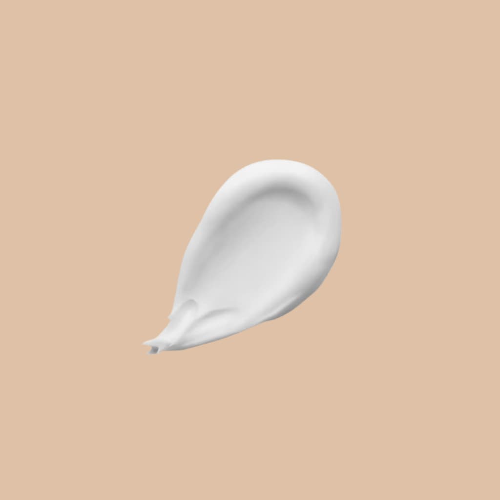 White cream smear on a beige background